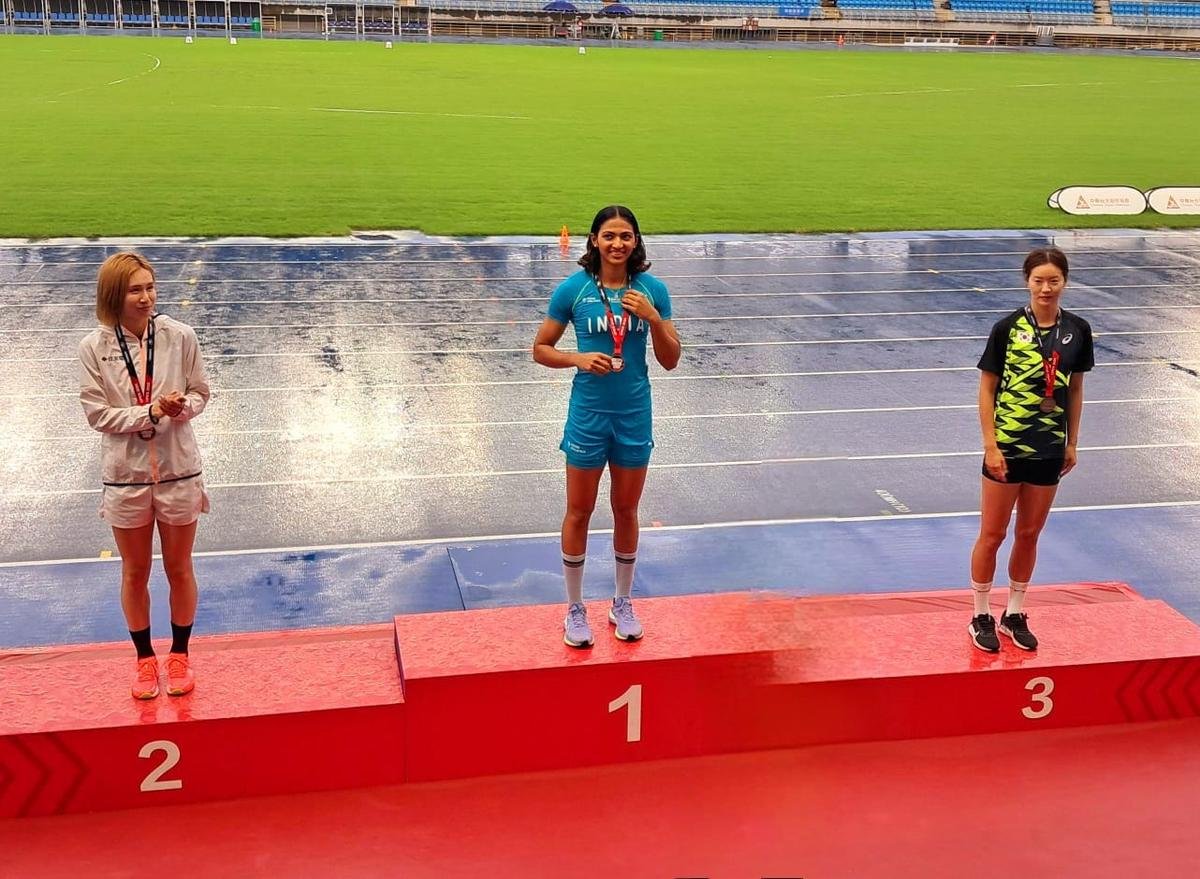 Nayana James poses on the podium after winning gold at the Taiwan Open.